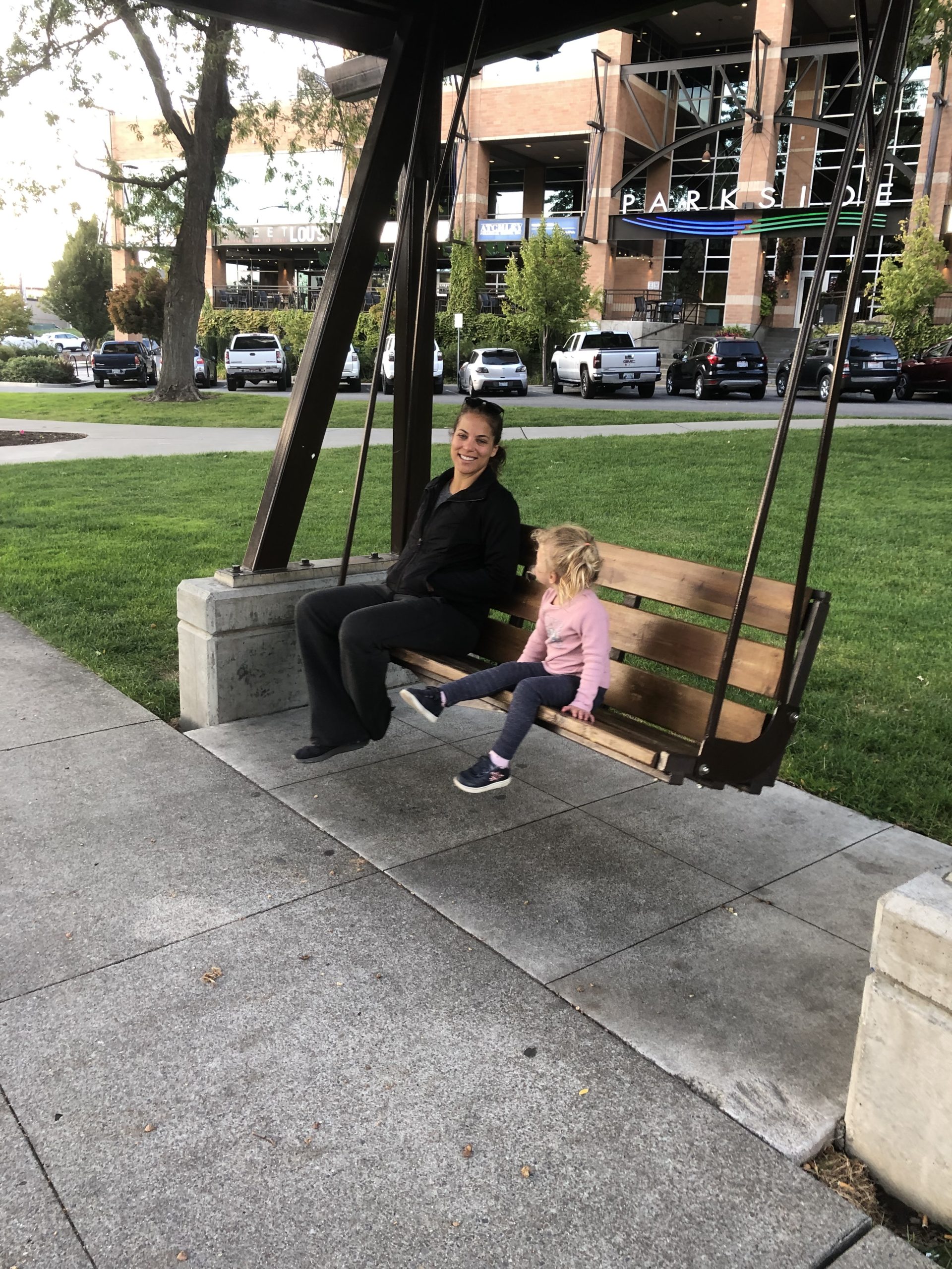 Wooden porch swing with mother and child